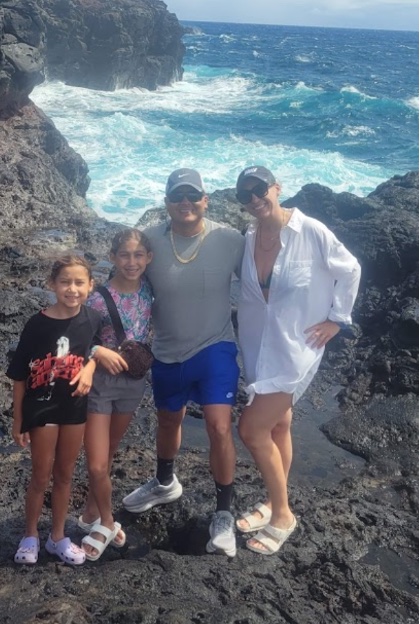 Jose Valdez with his wife Mejra and daughters Nalah and Lunah, on the rocks by the ocean